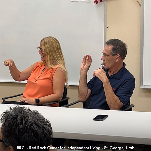 A woman and man communicating with sign language