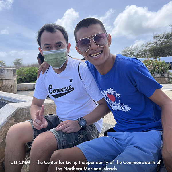 Two men sitting outside in a garden